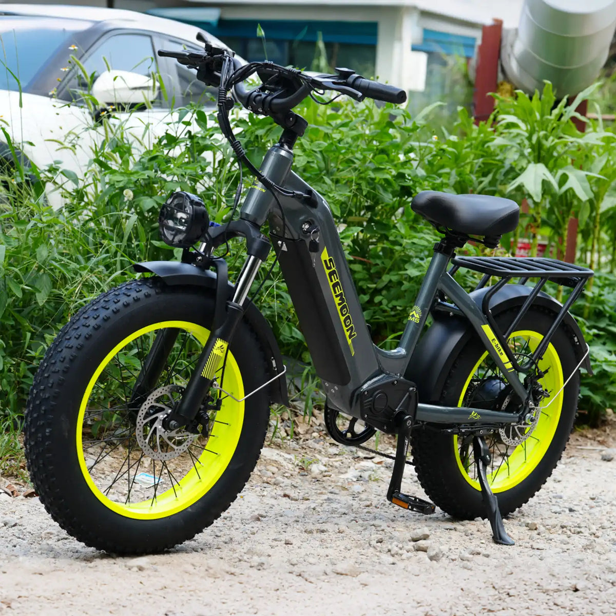 SM5 electric bike three-quarter view with yellow rim accents in an outdoor setting